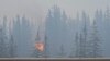 Blaze in Canadian tourist town still out of control, but rain helping firefighters 