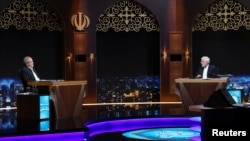 Presidential candidates Masoud Pezeshkian, left, and Saeed Jalili ​attend an election debate at a television studio in Tehran, Iran, July 2, 2024. (Morteza Fakhri Nezhad/IRIB/West Asia News Agency/Handout via Reuters)