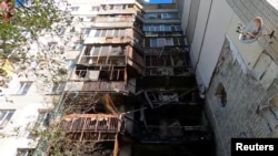 Exterior view of a heavily damaged apartment after what officials say was a Russian overnight shelling in Kherson, Aug. 7, 2023 in this still image obtained from social media video. Telegram/Oleksandr Prokudin via Reuters 