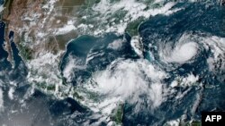 This image obtained from the U.S. National Oceanic and Atmospheric Administration (NOAA), shows tropical Storm Idalia (C) off the coast of Mexico, Aug. 27, 2023.