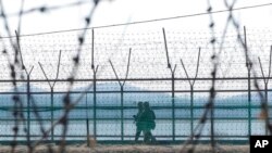 South Korean army soldiers patrol along the barbed-wire fence in Paju, South Korea, near the border with North Korea, Feb. 16, 2023. 