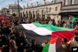 FILE - People hold a giant Palestinian flag during a pro-Palestinian protest in Istanbul, Turkey, April 21, 2024.