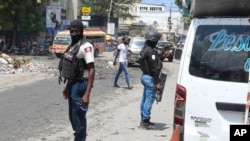 FILE - National Police patrol an intersection amid gang violence in Port-au-Prince, Haiti, April 8, 2024.