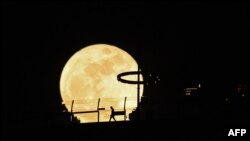 A super blue moon rises behind Marina Bay Sands observation deck in Singapore, Aug. 31, 2023. 
