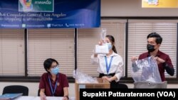 Officers sort received overseas absentee ballots, preparing to pack in diplomatic pouches and send them back to count in Thailand at the Royal Thai Consulate-General of Los Angeles, CA.