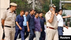 Police officers escort Chief Minister of Delhi and Aam Aadmi Party (AAP) Arvind Kejriwal as he leaves the court after a hearing in New Delhi, March 28, 2024. 