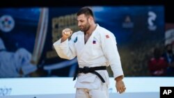 FILE - Arman Adamian of Russia celebrates a win during the men's - 100kg final match at the Grand Slam Paris 2021 Judo tournament, in Paris, France, Oct. 17, 2021.