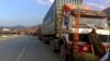 FILE - Stranded trucks loaded with supplies for Afghanistan, line up on a highway at the key border crossing point of Torkham in Pakistan along the Afghan border, Feb. 21, 2023. The border crossing has since reopened.