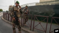Soldiers patrol next to the Ozar Hatorah jewish school in Creteil, outside Paris, Oct. 16, 2023.