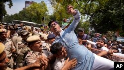 Police detain a member of the youth arm of India's Congress Party during a protest near Parliament House in New Delhi, India, July 20, 2023. The protest was against deadly ethnic clashes in the country's northeast after a video showed two women being assaulted by a mob.