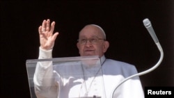 FILE - Pope Francis waves at the crowd, who are gathered on St Peter's Square during the Angelus prayer, from his window at the Vatican, Jan. 21, 2024. (Vatican Media/­Handout via Reuters)