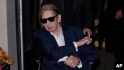 FILE - Shane MacGowan arrives at the Shane MacGowan, The Eternal Buzz & The Crock of Gold Exhibition in London, Britain, Oct. 11, 2022. (Photo by Scott Garfitt/Invision via AP)