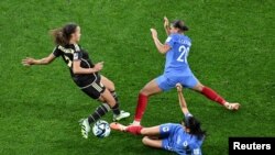 Jamaica's Solai Washington, left, fights for the ball against France's Estelle Cascarino and Kenza Dali during the FIFA Women’s World Cup at Sydney Football Stadium, in Sydney, Australia, July 23, 2023.