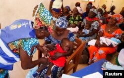 A nurse administers a malaria vaccine to an infant at the health center in Datcheka, Cameroon, Jan. 22, 2024.