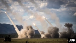 FILE - Missiles are launched from a U.S. military HIMARS system during joint military drills at a firing range in Shoalwater Bay, Australia, July 22, 2023. Taiwan reportedly is considering buying billions of dollars worth of weapons, including HIMARS, from the U.S. 