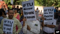 Activists of several student and left organizations hold placards during a protest against the arrest of the editor of a news website and one of its administrators after raiding the homes of journalists, in New Delhi, Oct. 4, 2023.