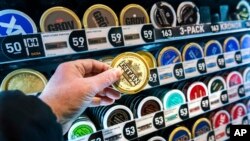 FILE - A man holds a box of snus (smokeless tobacco), at a store in Stockholm, on Jan. 23, 2023.