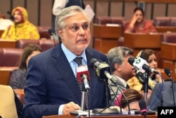 FILE - Pakistan's Finance Minister Ishaq Dar speaks in the national assembly in Islamabad, June 9, 2023, in this handout photograph taken by the Pakistan National Assembly.