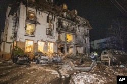 FILE - Firefighters examine the site of Russia's missile attack that hit a hotel in Kharkiv, Ukraine, Jan. 10, 2024. (Ukrainian Emergency Service via AP)