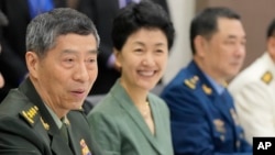 FILE- Chinese Defense Minister Gen. Li Shangfu, left, talks with Singapore Defense Minister Ng Eng Hen, unseen, at the defense ministry in Singapore, June 1, 2023.