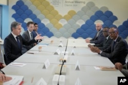 FILE - U.S. Secretary of State Antony Blinken, left, attends a meeting with Rwandan President Paul Kagame, right, at the Annual Meeting of World Economic Forum in Davos, Switzerland, Jan. 16, 2024.