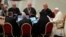 Pope Francis, right, speaks with a group of voting members during the opening session of the 16th General Assembly of the Synod of Bishops in the Paul VI Hall at the Vatican, Oct. 4, 2023