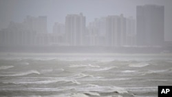 In this photo released by Xinhua News Agency, waves are seen off the coast of Fuzhou, southeast China's Fujian Province, July 27, 2023. 