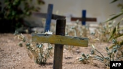 FILE - Wooden crosses made with the remains of boats used by migrants to cross the Mediterranean sea are seen in the cemetery where victims of shipwrecks are buried, on the island of Lampedusa, Italy, Sept. 25, 2023.