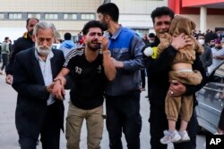 Families of victims of the explosions gather at the courtyard of a hospital in the city of Kerman, about 510 miles (820 kilometers) southeast of the capital Tehran, Iran, Jan. 3, 2024.
