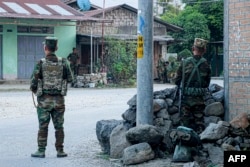 Fighters of the ethnic armed group Ta'ang National Liberation Army (TNLA) stand guard in the town of Namhkam in northern Shan state, Myanmar, Nov. 9, 2023.