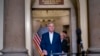 Speaker of the House Kevin McCarthy, joined at right by his top negotiator on the debt limit, Rep. Patrick McHenry, smiles as he arrives to talk to reporters at the Capitol in Washington, May 28, 2023. 