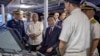 Japan's Prime Minister Fumio Kishida, center, sits on the bridge of a ship at the Philippine Coast Guard headquarters on Nov. 4, 2023, in Manila. Kishida was in the Philippines for talks about a potential defense pact.