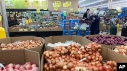 FILE - People shop at a grocery store in Buffalo Grove, Illinois, March 19, 2023. 