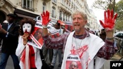 FILE - People demonstrate on Sept. 12, 2011 in Paris against the visit in France of Rwanda's President Paul Kagame who accused him of jailing opponents and cracking down on press freedom.