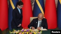 Minister of Foreign Affairs and Trade of Nauru Lionel Aingimea signs the Joint Communique on the Resumption of Diplomatic Relations between the People's Republic of China and the Republic of Nauru, in Beijing, Jan 24, 2024. 