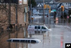 Cars are submerged in a area near the Saddle River in Lodi, New Jersey, Jan. 10, 2024.