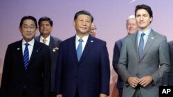Japan's Prime Minister Fumio Kishida, Chinese President Xi Jinping and Canada's Prime Minister Justin Trudeau poses for a photo at the annual Asia-Pacific Economic Cooperation summit, Nov. 16, 2023, in San Francisco.