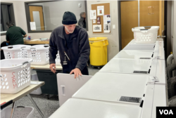 Thomas McDonald coordinates the laundry operations and the 200 loads washed per day. As a former client, he recovered from drug and alcohol addiction and returned to work at the mission, Jan. 17, 2023. (Carolyn Presutt/VOA)