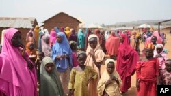 People wait for news about the kidnapped LEA Primary and Secondary School Kuriga students in Kuriga, Kaduna, Nigeria, March 9, 2024.