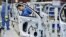 FILE - Employees work on assembling vehicles at a plant of SAIC Volkswagen in Urumqi, Xinjiang, China, on Sept. 4, 2018. (China Daily via Reuters)