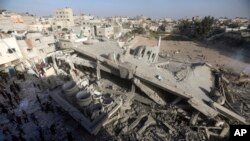 Palestinians inspect the damage of a destroyed mosque following an Israeli airstrike in Khan Younis refugee camp, southern Gaza Strip, Nov. 8, 2023.