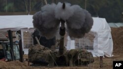 An Israeli mobile artillery unit fires a shell from southern Israel towards the Gaza Strip, in a position near the Israel-Gaza border , Jan. 14, 2024. 
