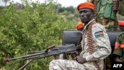A South Sudanese military police officer sits on a truck while monitoring the area as troops belonging to the South Sudanese Unified Forces take part in a deployment ceremony at the Luri Military Training Centre in Juba, Nov. 15, 2023. 