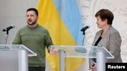 Ukraine's President Volodymyr Zelenskyy and International Monetary Fund Managing Director Kristalina Georgieva speak to the press following a meeting at the IMF in Washington, Dec. 11, 2023.