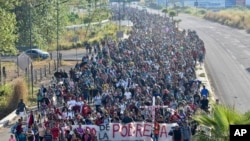 FILE - Migrants depart from Tapachula, Mexico, Dec. 24, 2023.