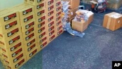 This undated photo provided by the United States Department of Justice shows boxes of ammo displayed after confiscation.