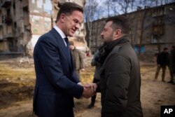 FILE - In this photo provided by the Ukrainian Presidential Press Office, President Volodymyr Zelenskyy, right, and then-Netherlands Prime Minister Mark Rutte talk near areas destroyed by Russian missiles in Kharkiv, Ukraine, March 1, 2024. Rutte now leads NATO.