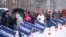 People wait to enter a Republican presidential candidate former President Donald Trump campaign event during a winter snowstorm in Atkinson, New Hampshire, Jan. 16, 2024.