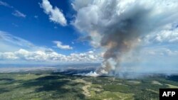 This July 27, 2023, image from the British Columbia Wildfire Service shows smoke from the the Ross Moore wildfire south of Kamloops, British Columbia, Canada.