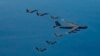 A U.S. Air Force B-52H bomber, center, F-16 fighter jets, South Korean Air Force F-15K fighter jets, left top, and Japanese Air Force F-2 fighter jets, left bottom, fly in formation during a joint air drill near Korean Peninsula, Oct. 22, 2023. 
